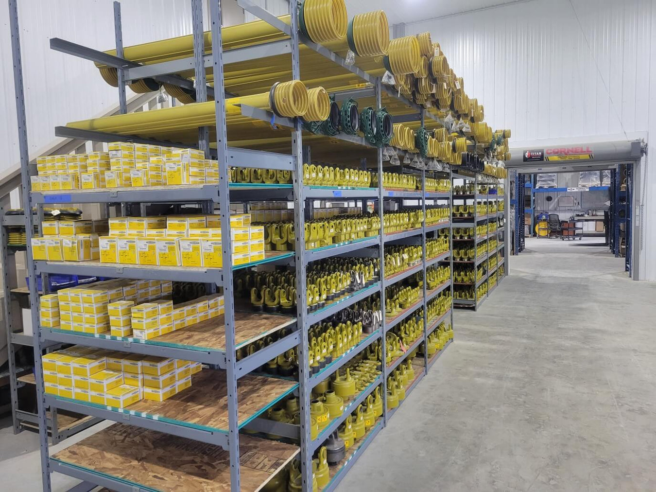 Aftermarket Farm warehouse shelving full of yellow Walterscheid - PTO Cross Bearing Kits, yokes, guards and more