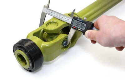 Caliper measuring installed cross bearing between PTO yokes for precise driveline sizing